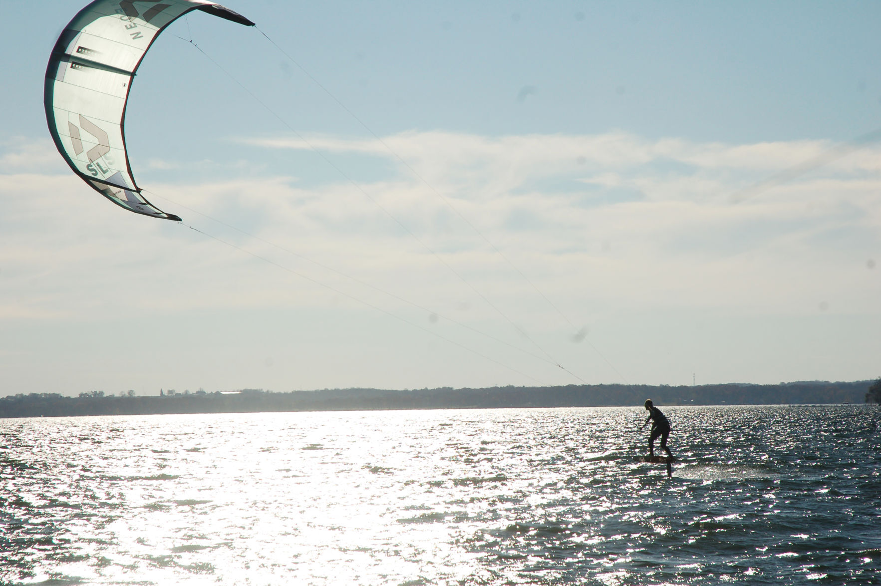 Charlie Vogel kiteboarding into the sun Lake Geneva